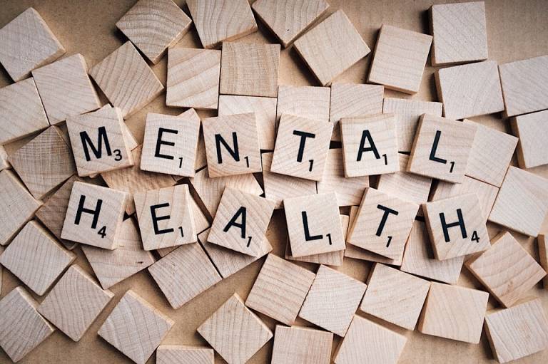 Scrabble letters than spell the words mental health