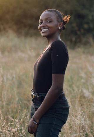 Teenage girl in a field, smiling