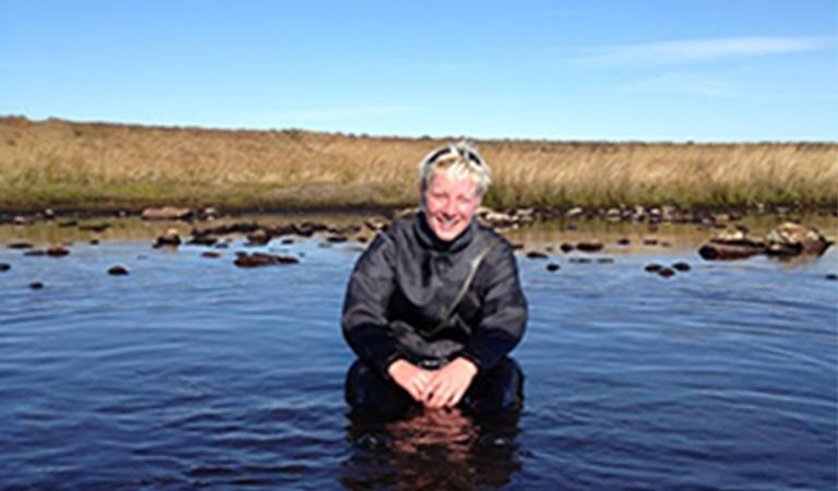 PhD Student at UCL Geography, Hannah Robson, in a pond