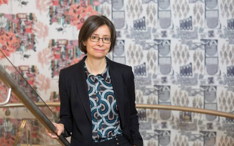 Prof Paola Lettieri in front of stairway artwork