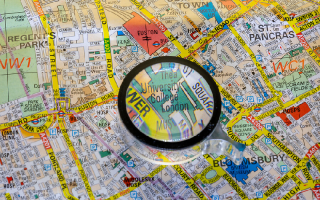 A map of central London with University College London under a magnifying glass.