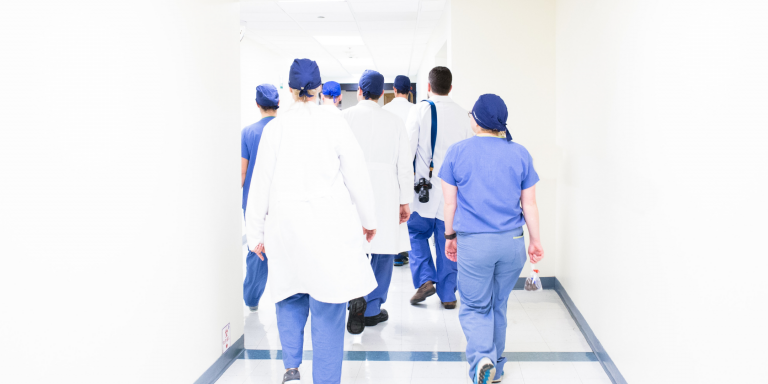 Group of healthcare leaders walking down a corridor