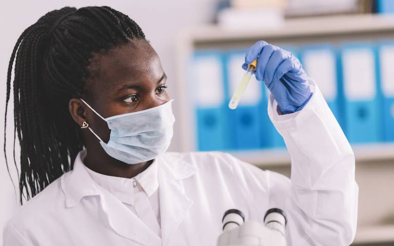 Female African researcher testing COVID-19 samples in a lab