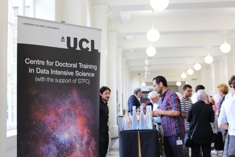 Reception with drinks and poster with text: Centre for doctoral science in Data Intensive Science