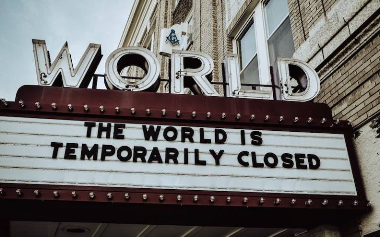 movie theatre sign that reads "The World is Temporarily Closed"