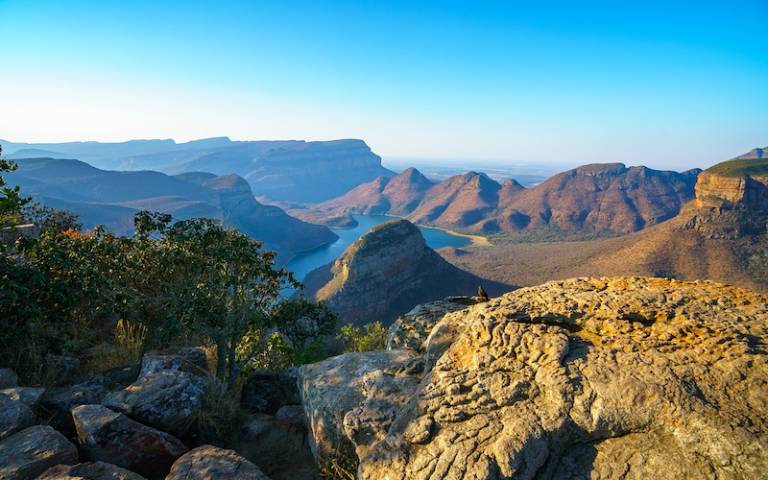 view of three rondavels and the blyde river canyon at sunset in south africa