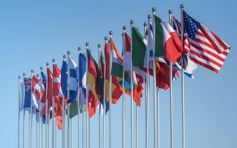 row of various world flags on poles
