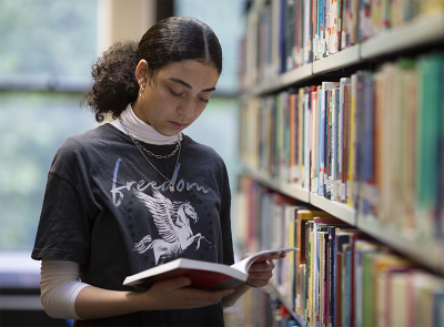 Female student browses a book in the IOE library, the largest education library in Europe