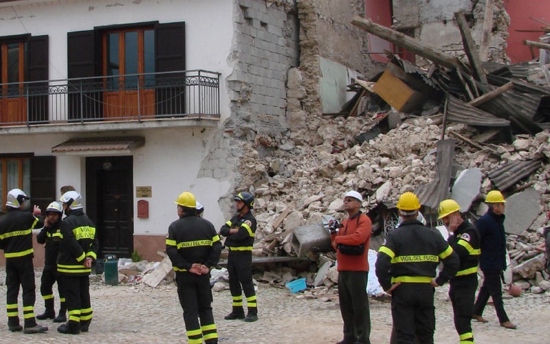 Firepeople outside a collapsed building