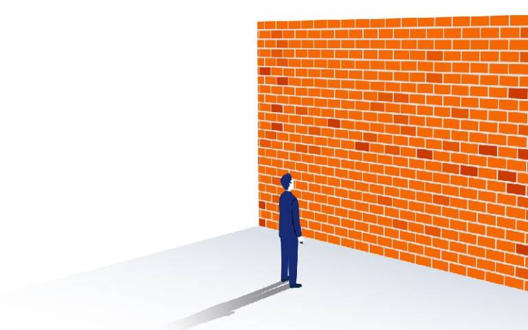 Man standing in front of a wall/barrier