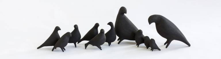 Black ceramic birds on white background
