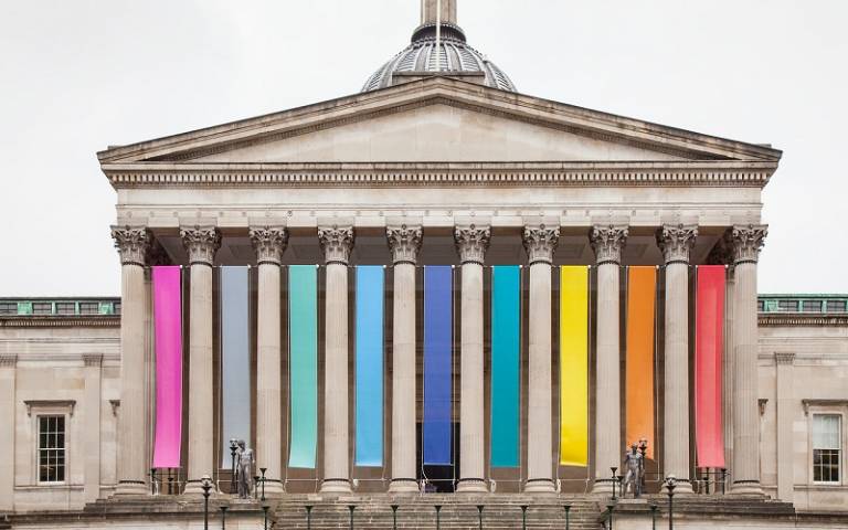 UCL Portico building sporting multicoloured flags 