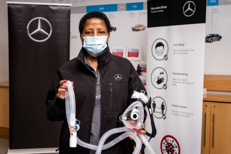 Mercedes-Benz South Africa employee holds a CPAP breathing circuit
