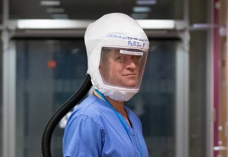 A doctor wearing a protective helmet