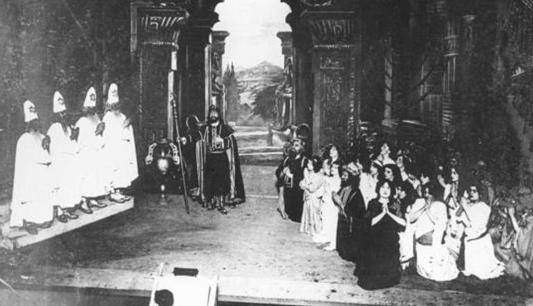 black and white photo of a stage featuring religious figures