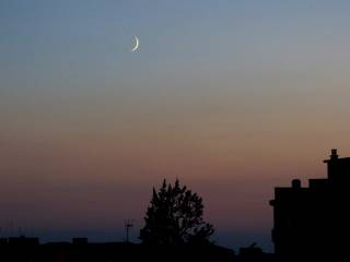 snapshot of the new moon crescent moon at dusk