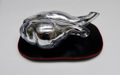 Bewitched is a mirrored glass heart that sits on a traditional black wooden base as if it is a specimen in a museum. 