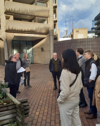 Peter Burley leads a group of York alumni on a guided walk round the Barbican Estate in the City of London.