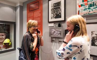 Two women on old phones as part of the Women in the Miner's Strike Exhibition at the National Coal Mining Museum
