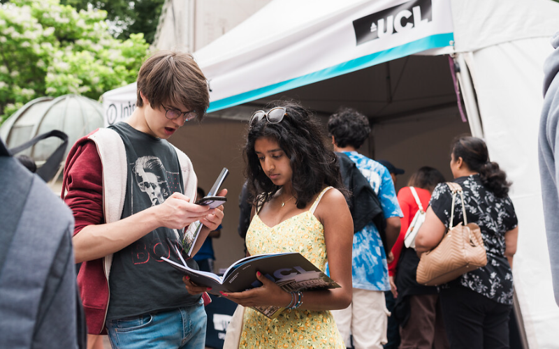 two students at UCL open day reading book