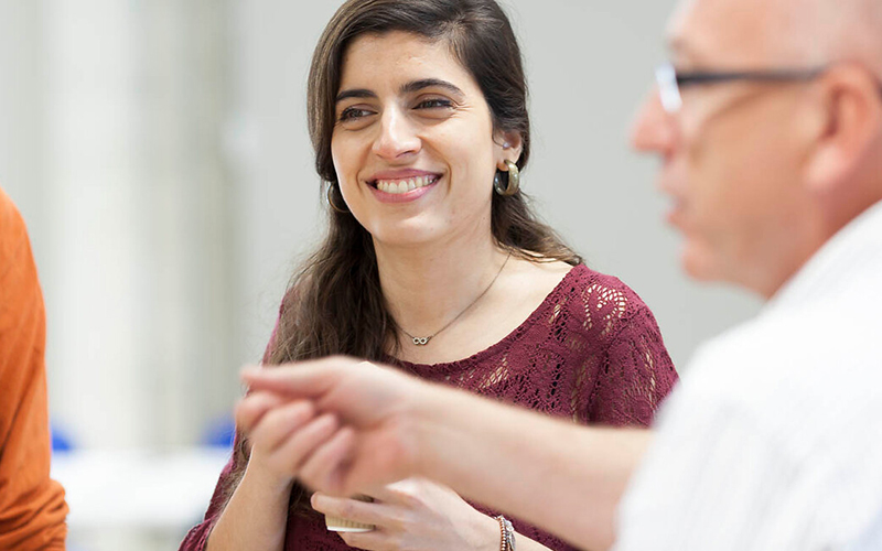Woman smiling to talking to colleagues