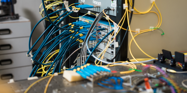 Experimental equipment showing many optical cables routing between different devices.