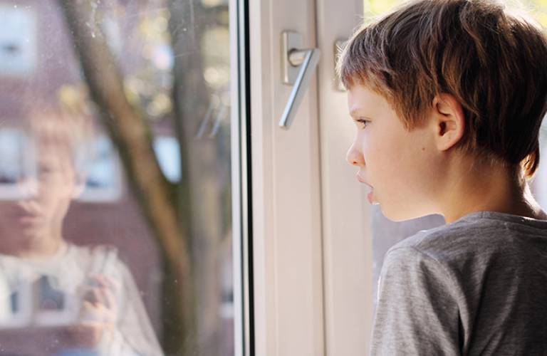 Boy looking out of window