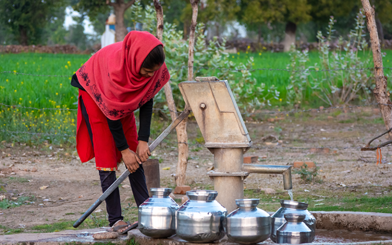 Women collecting water from a water pump