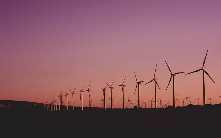 Wind turbines against a purple sky