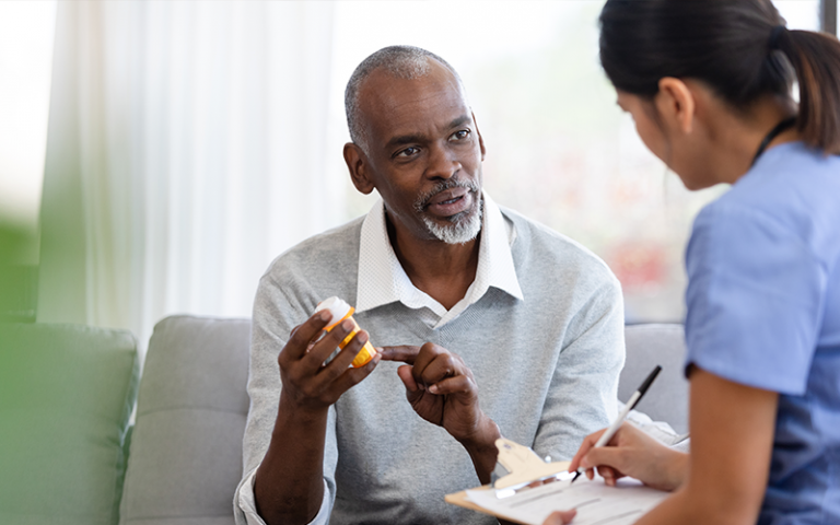 The senior man asks the visiting homehealth nurse about the side effects of his perscription.