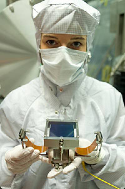 MSSL researcher Dr Magdalena Szafraniec displays one of the 36 large area CCDs from e2v