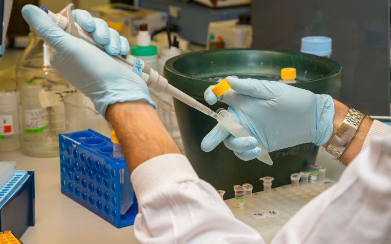Image of researcher using pipette in laboratory