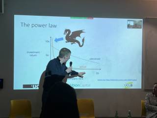 David Grimm points to a PowerPoint showing a slide on power law