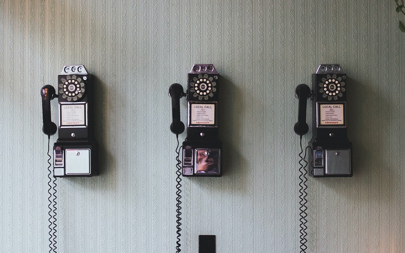 vintage telephone on the wall, Photo by Pavan Trikutam on Unsplash
