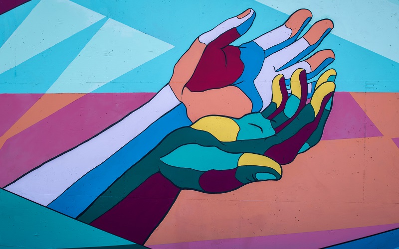 Mural of colourful hands, photo by Tim Mossholder on Unsplash