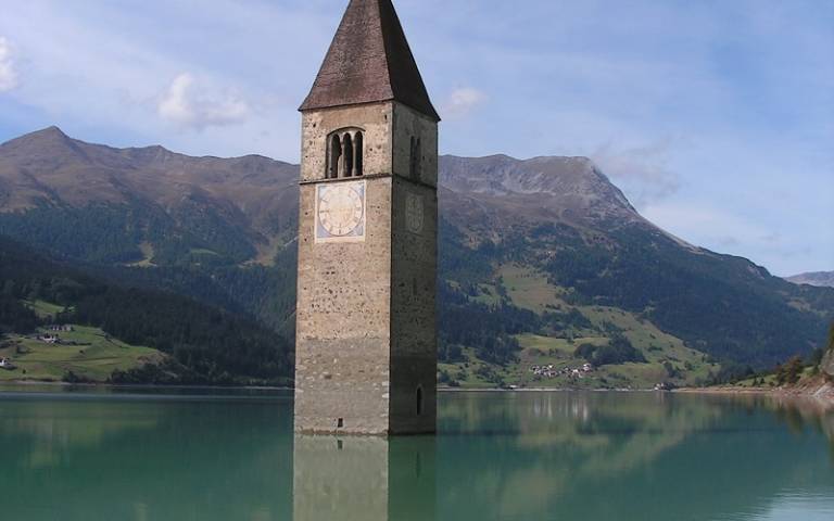 Church belltower half-submerged in water