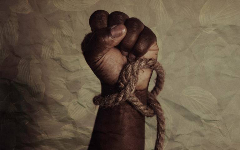 hand tied with rope, Photo by Tasha Jolley on Unsplash 