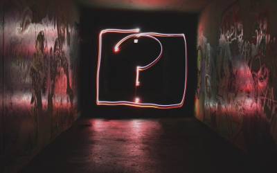 Question mark in neon signage, credit Emily Morter on Unsplash