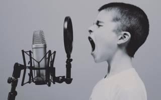 child shouting into a microphone