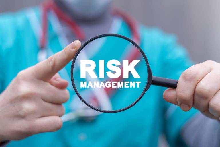 Picture of a surgeon with the words Risk Management in the center