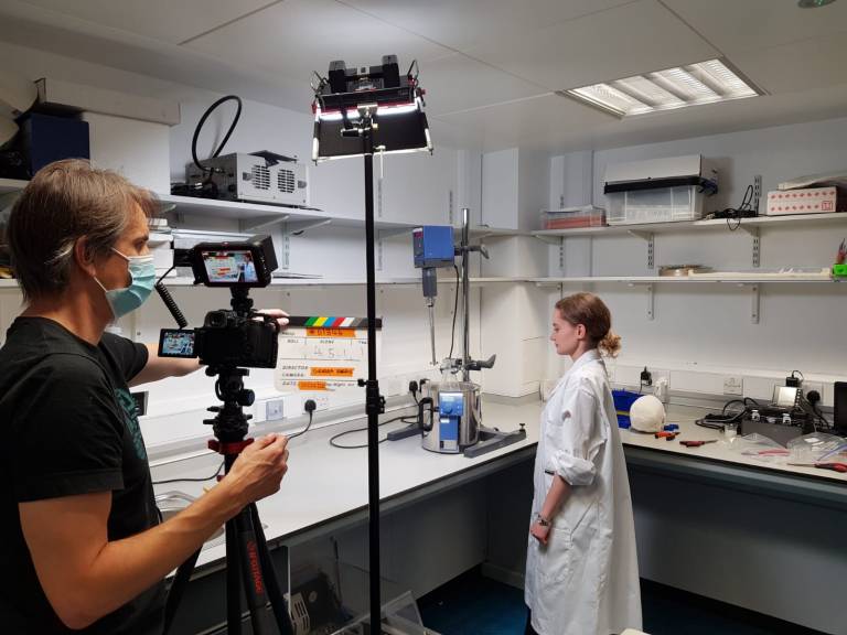 Eleanor Mackle is in a laboratory with a camera preparing to film a video