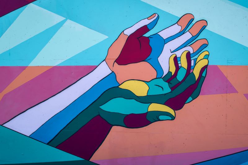 Colourful hands mural. Photo by Tim Mossholder on Unsplash
