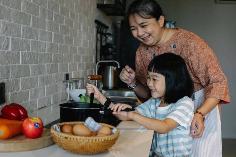 Asian woman with granddaughter preparing food. Photo by Alex Green from Pexels