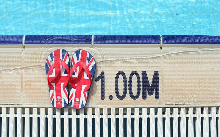 British flag print flip flops by a swimming pool