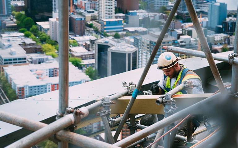 Builder on scaffolding. Image credit: Anthony Fomin via Unsplash.