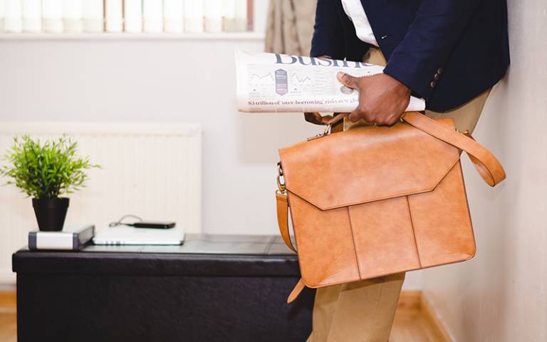 Business-casual man carrying leather briefcase. Credit: Adeolu Eletu / Unsplash