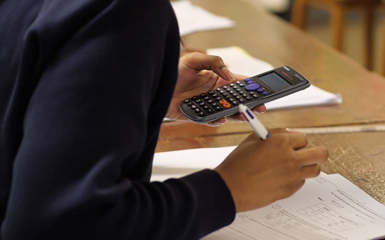 Student using a calculator in mathematics/science class