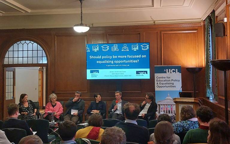 Panel members sitting in front of a presentation screen at the policy priorities launch event. Image permission: CEPEO UCL.