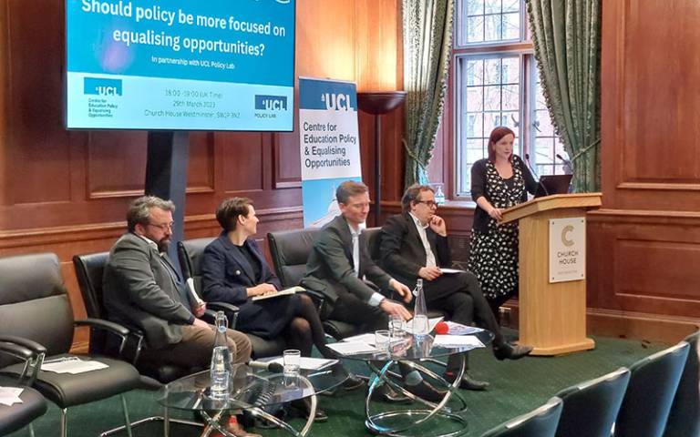 Panel members sitting in front of a presentation screen at the policy priorities launch event.