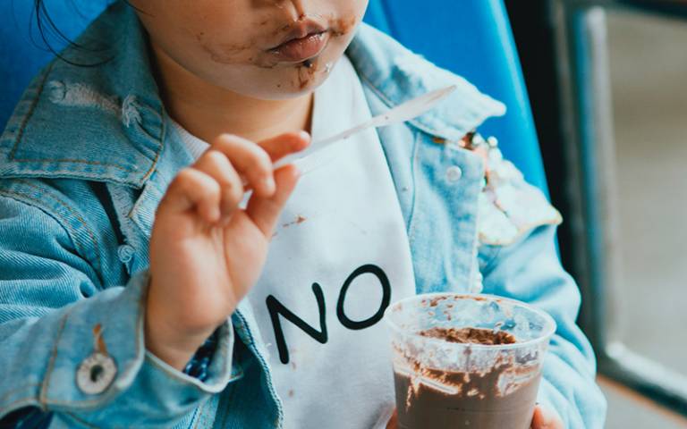 Child eating chocolate dessert